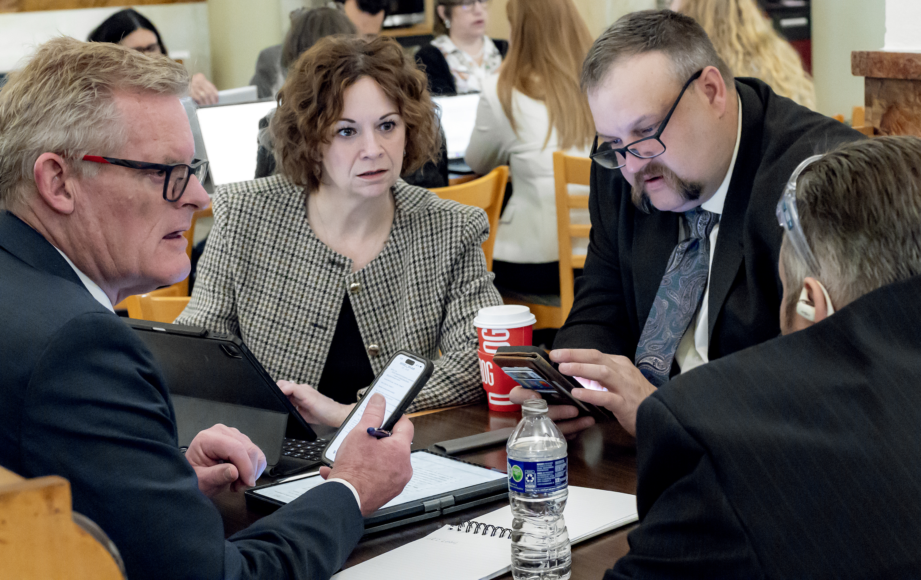 (L-R) Tim Dienst, GMR Director of Policy & Government Relations Tina Wells, Delta Co. Ambulance District MIH Director Reuben Farnsworth and Ute Pass Regional Ambualnce MIH Director James McGlaughlin discuss bill amendments and plan their testimony in the basement cafeteria of the Colorado State Capitol.