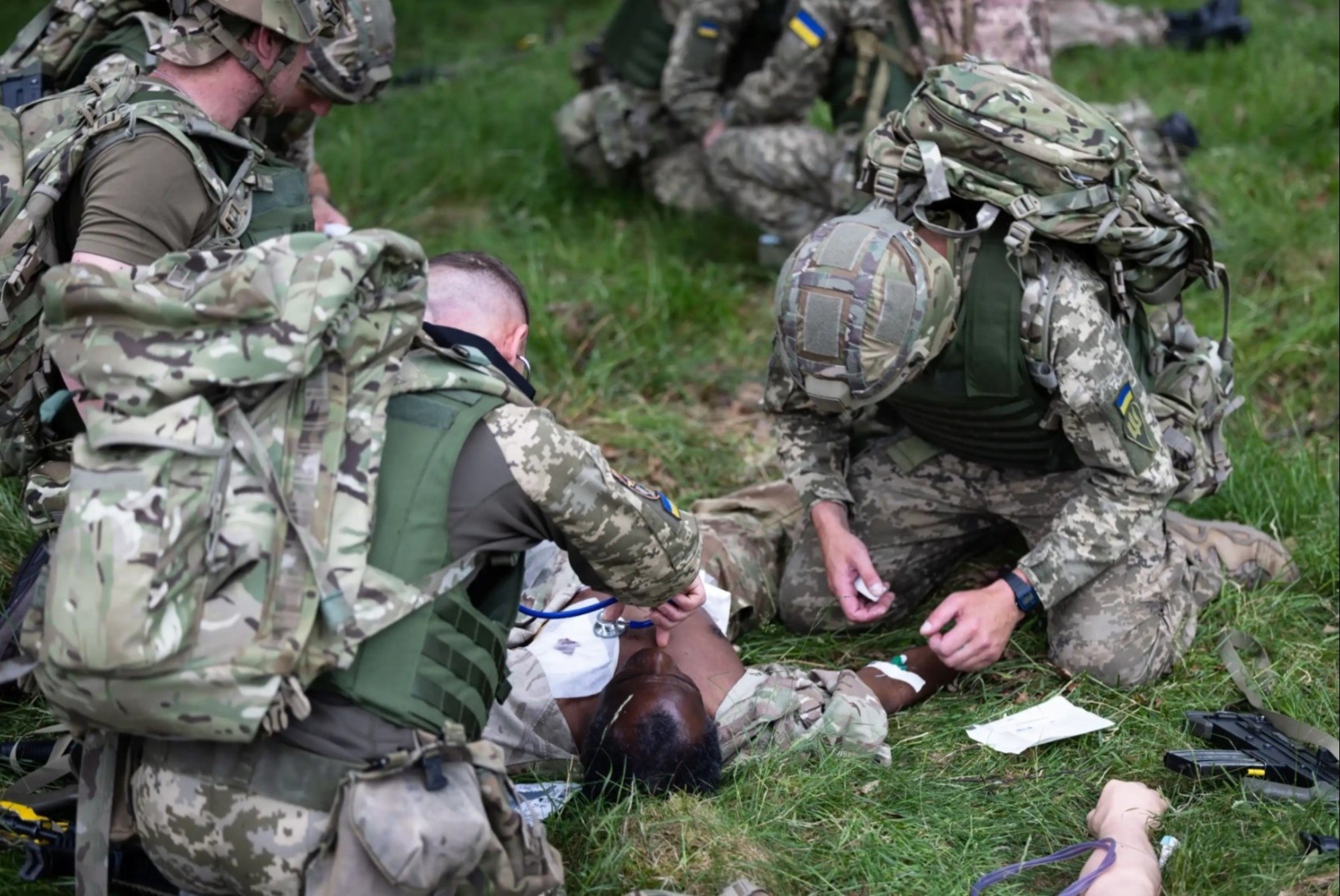 Image of simulated causality being treated by members of the Armed Forces of Ukraine.  Members of the Armed Forces of Ukraine are learning vital life-saving battlefield skills in the first combat medical training course of its kind to be delivered by the British Army and its international partners.    The five-week course, which began on the 29 May, has seen both current and new Ukrainian Armed Forces medics being trained in critical techniques such as providing medical care under fire, controlling heavy blood loss, and giving crucial pre-hospital emergency care.   Evidence from the battlefield and requests from Ukrainian personnel have been incorporated into the programme, with trainees being instructed on how best to optimise their own health so they are fit to fight. 