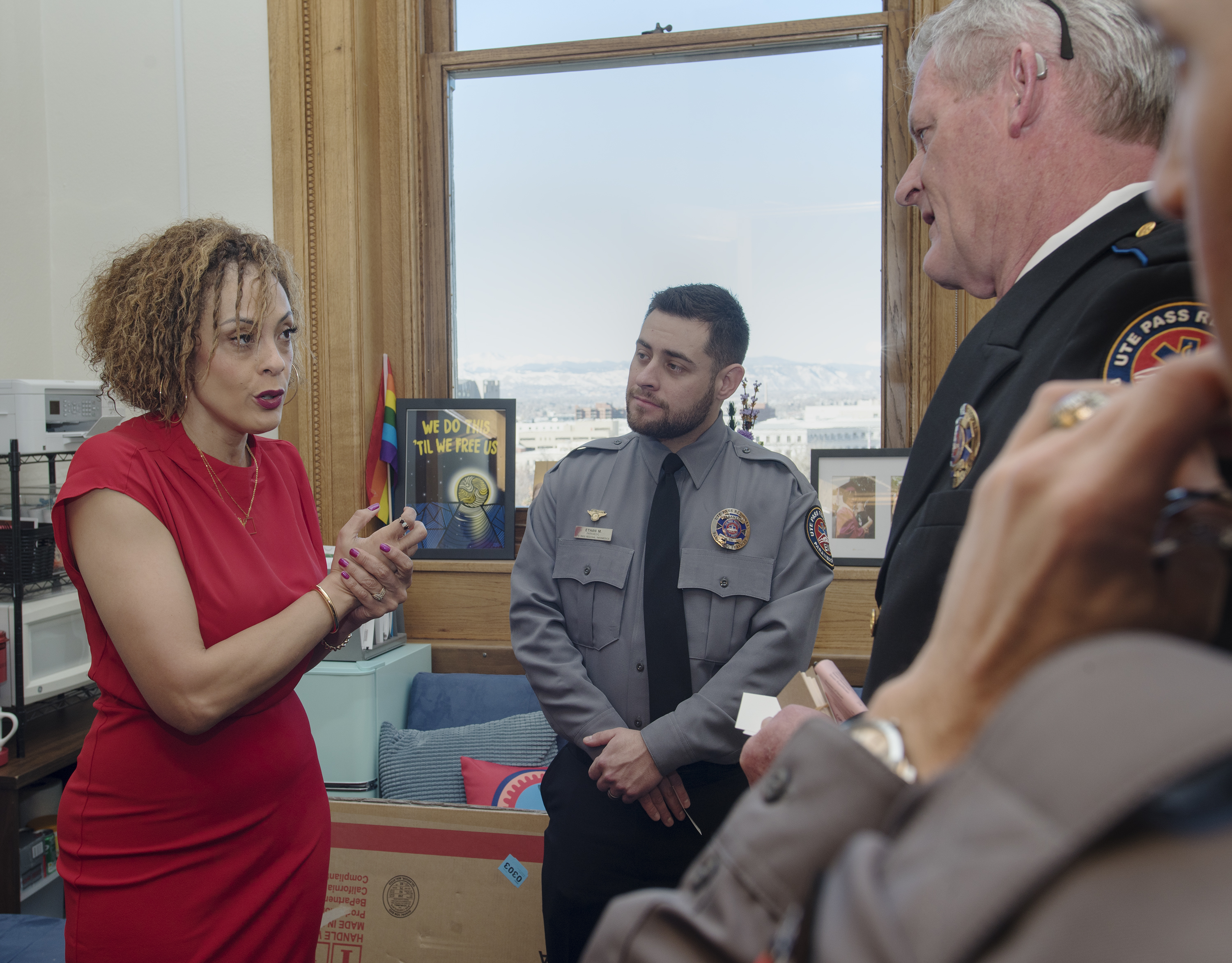 Rep. Elizabeth Epps (D), Denver, and Ute Pass Regional EMS paramedic Ethan Macaluso and CEO Tim Dienst engage in e passionate and friendly discussion about legislative bills.